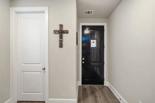 a view of a hallway with wooden floor