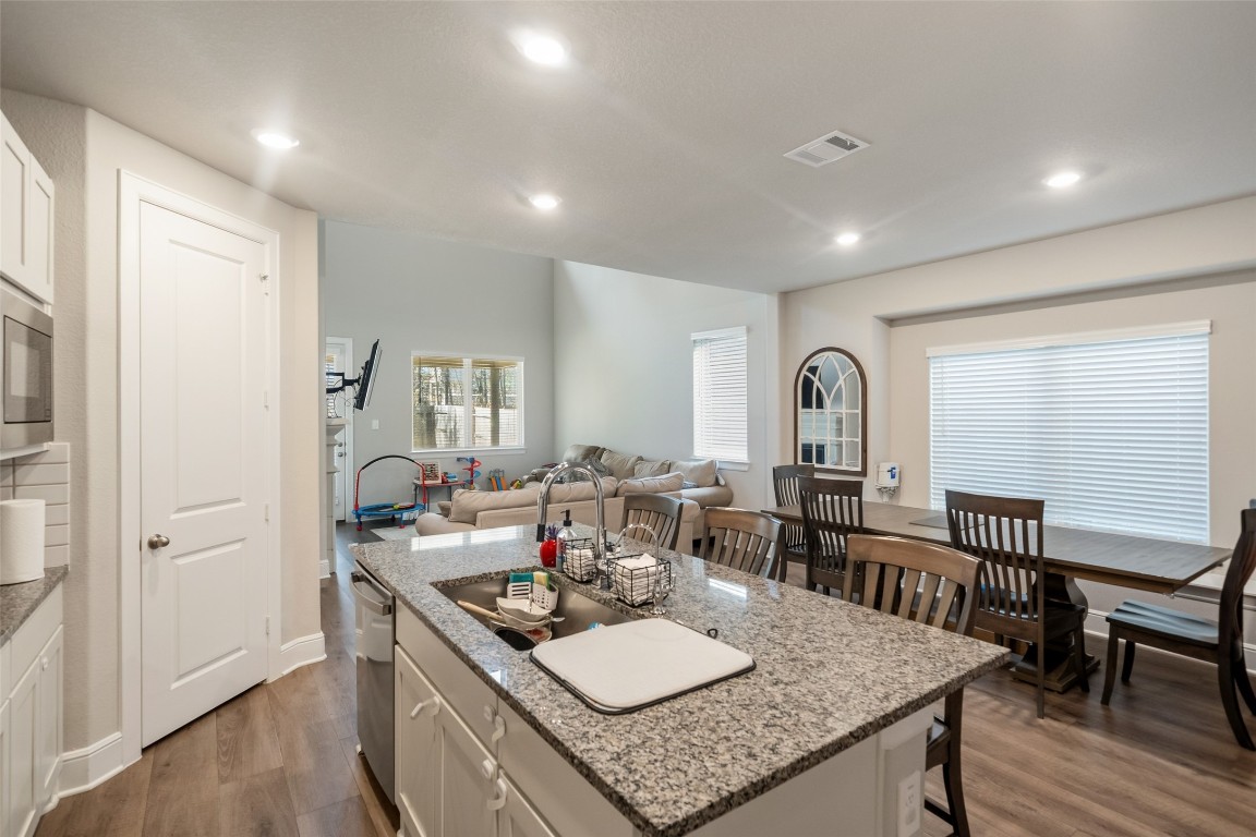27479 Vivace Drive Spring, TX 77386 - Photo 8 of 25 a kitchen with granite countertop lots of counter top space and dining table