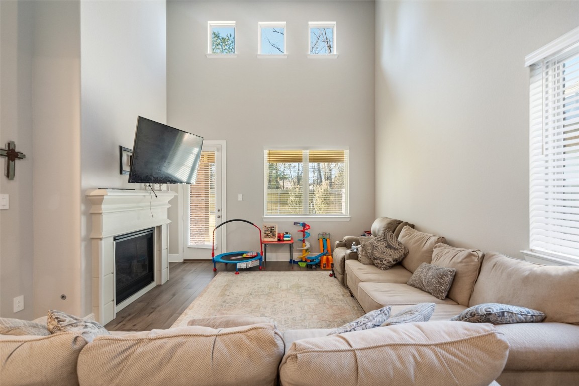 27479 Vivace Drive Spring, TX 77386 - Photo 10 of 25 a living room with furniture a fireplace and a flat screen tv