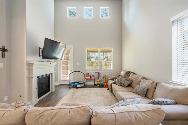 a living room with furniture a fireplace and a flat screen tv