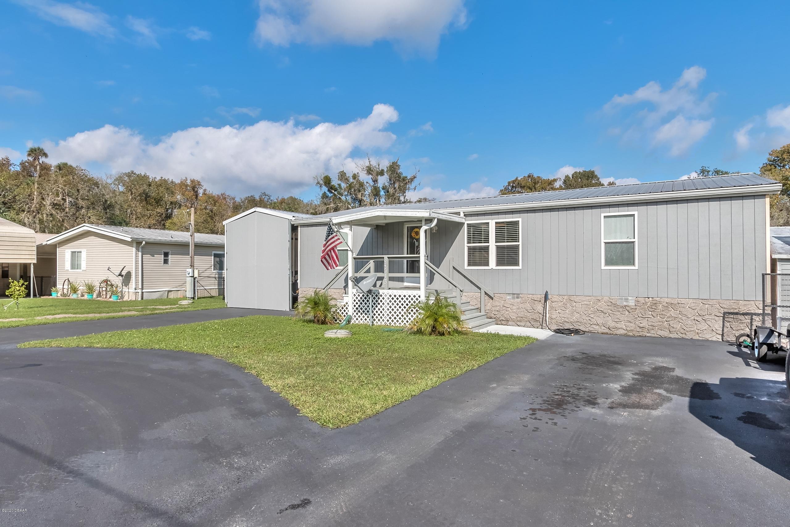 24513 Snail Road Astor, FL 32102 - Photo 1 of 40 a view of a house with backyard and garden
