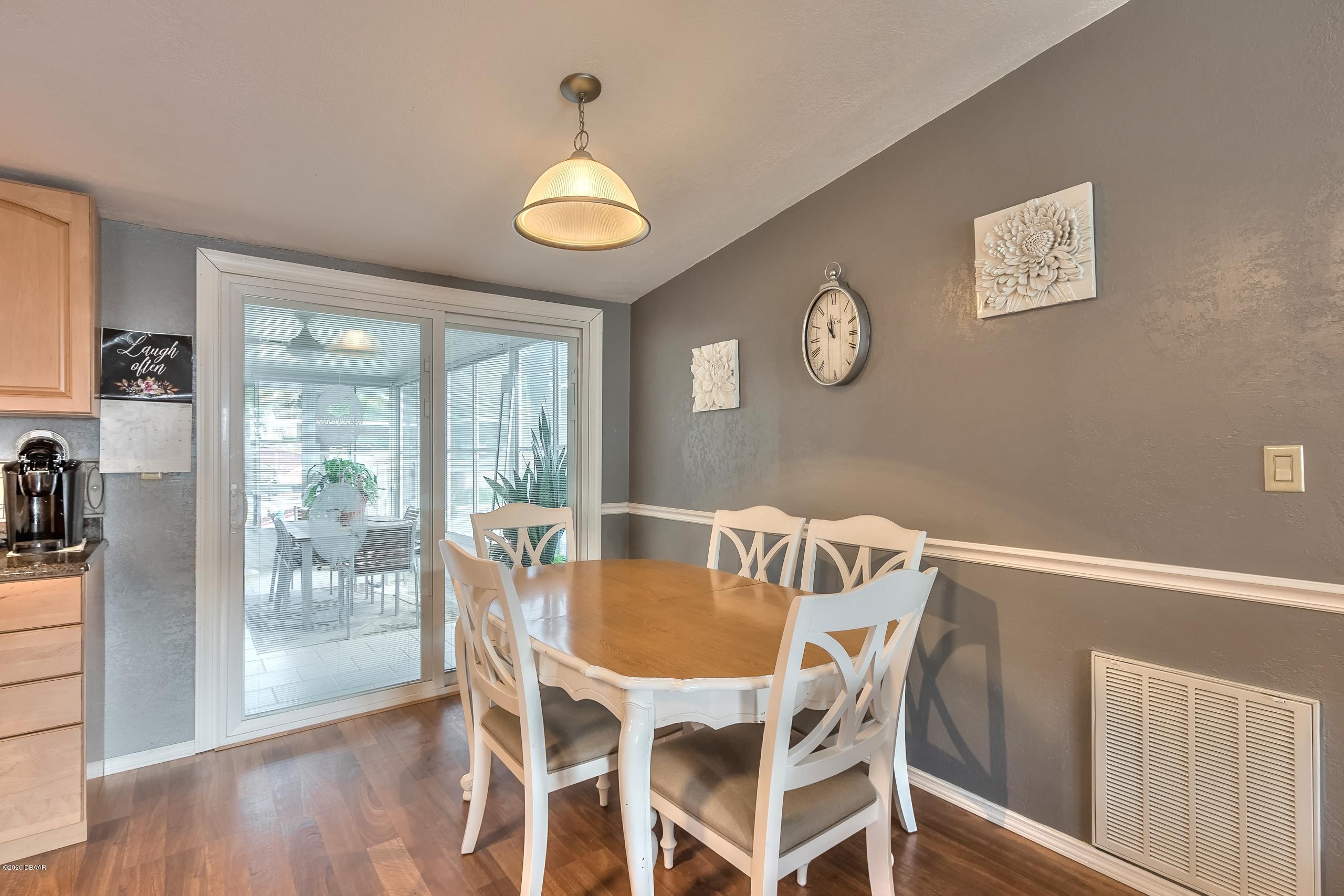 24513 Snail Road Astor, FL 32102 - Photo 16 of 40 a view of a dining room with furniture window and wooden floor