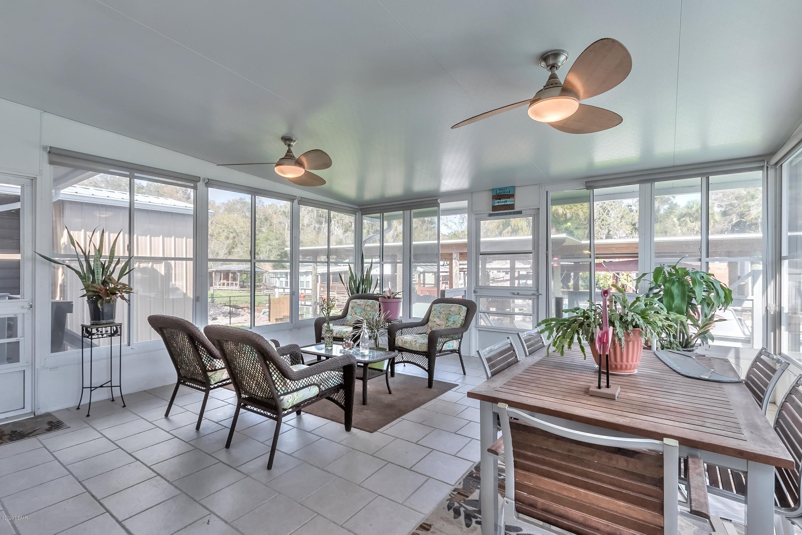 24513 Snail Road Astor, FL 32102 - Photo 24 of 40 a living room with furniture and a potted plant