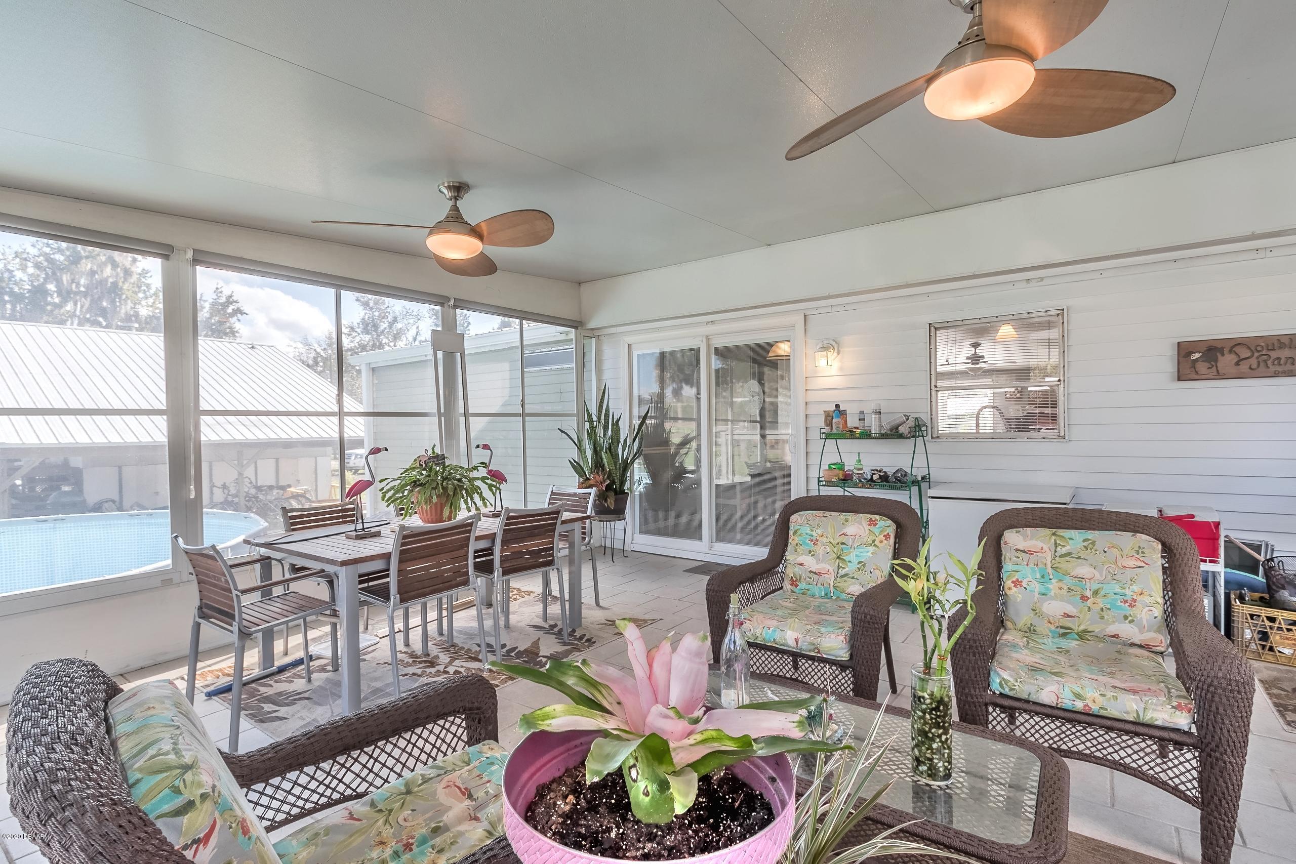 24513 Snail Road Astor, FL 32102 - Photo 25 of 40 a living room with fireplace furniture and a large window