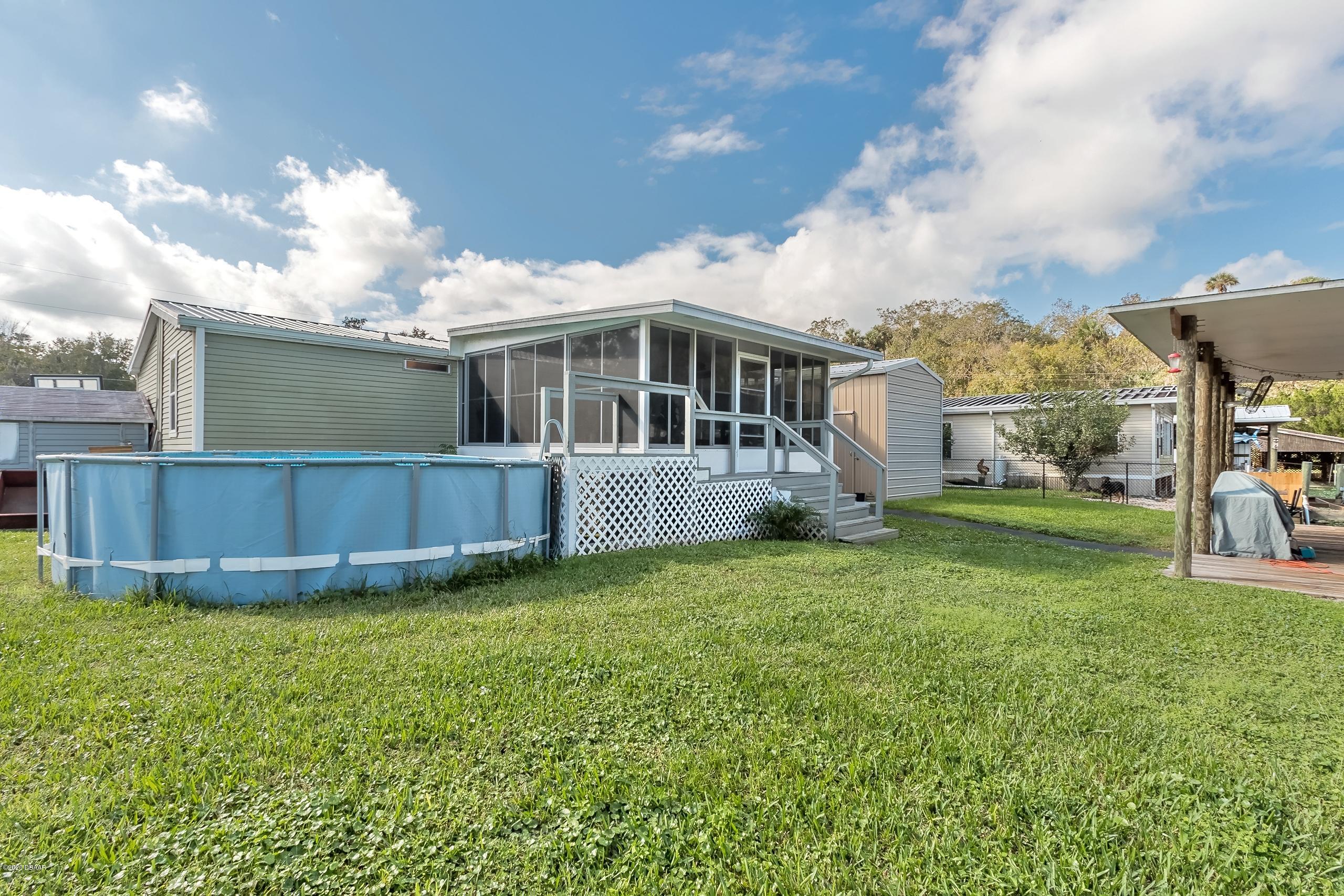 24513 Snail Road Astor, FL 32102 - Photo 28 of 40 a view of a house with a yard and sitting area