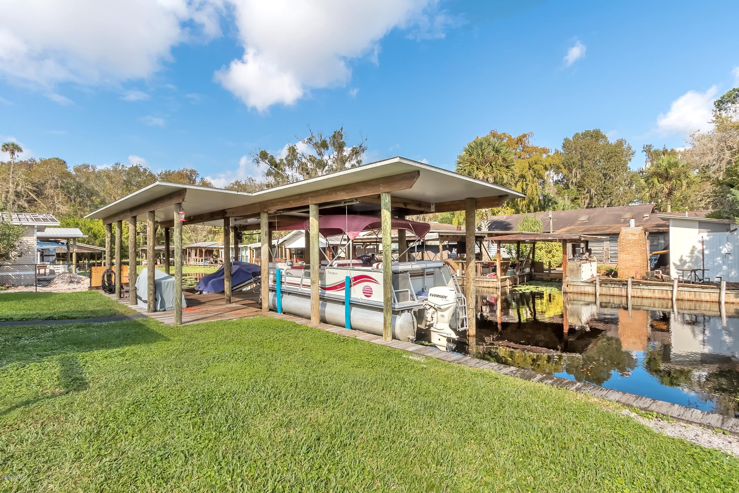 24513 Snail Road Astor, FL 32102 - Photo 29 of 40 a view of a house with swimming pool and porch
