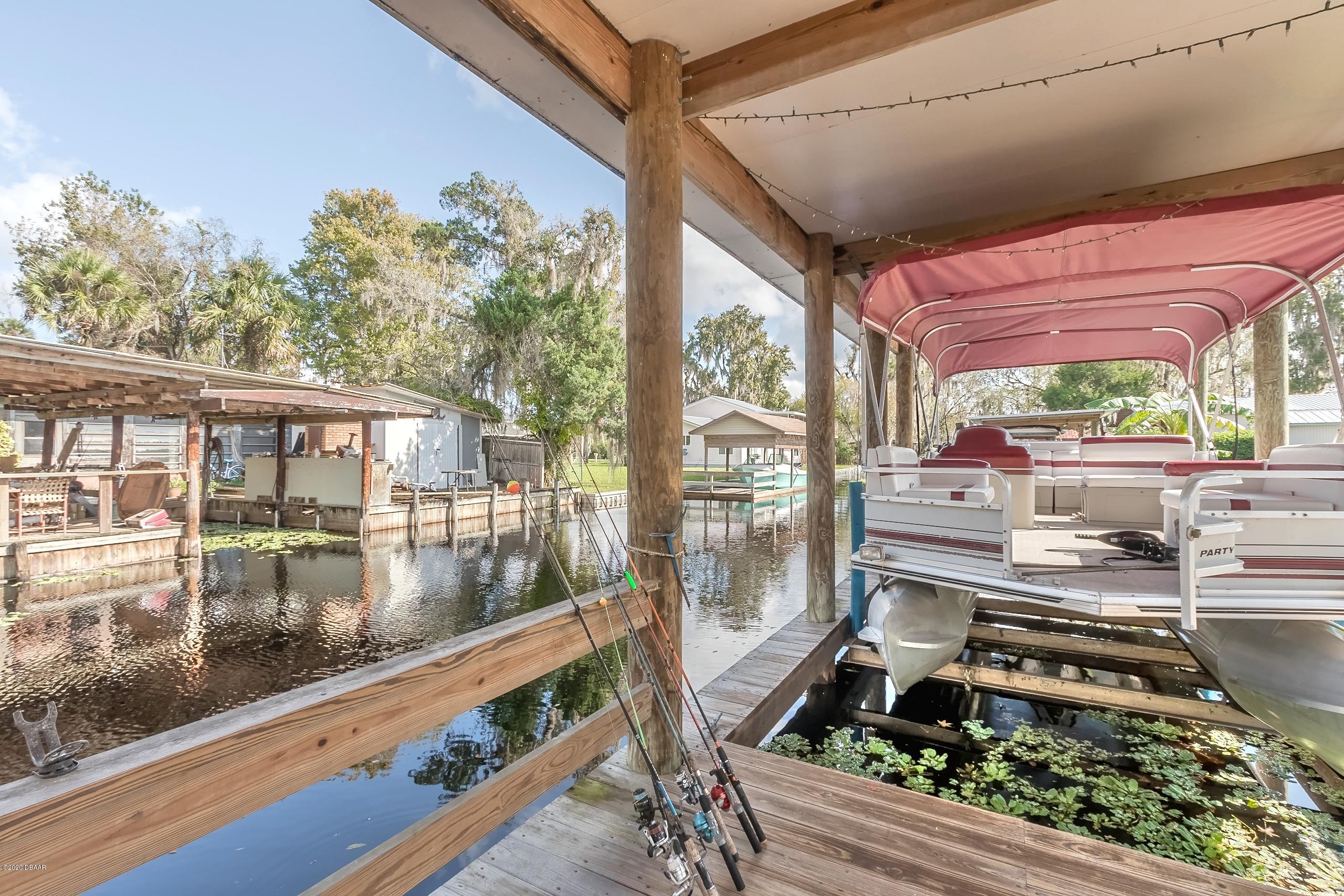24513 Snail Road Astor, FL 32102 - Photo 32 of 40 a outdoor space with lots of green space and glass windows