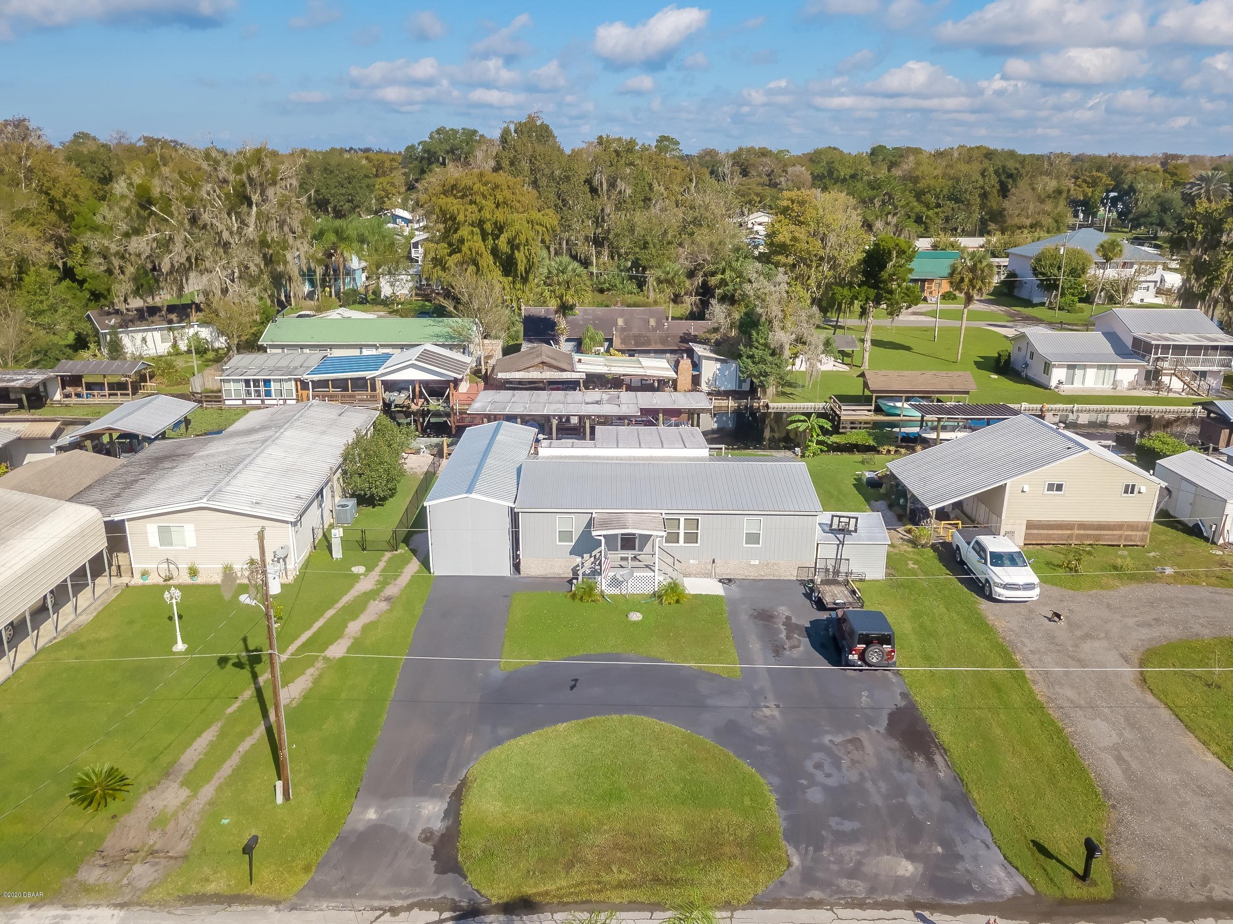 24513 Snail Road Astor, FL 32102 - Photo 34 of 40 an aerial view of residential houses with outdoor space and parking
