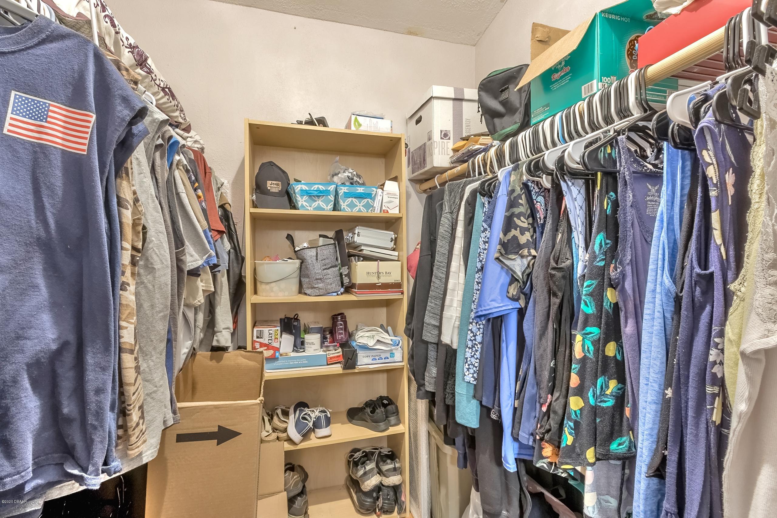 24513 Snail Road Astor, FL 32102 - Photo 8 of 40 a view of walk in closet with clothes and shoes