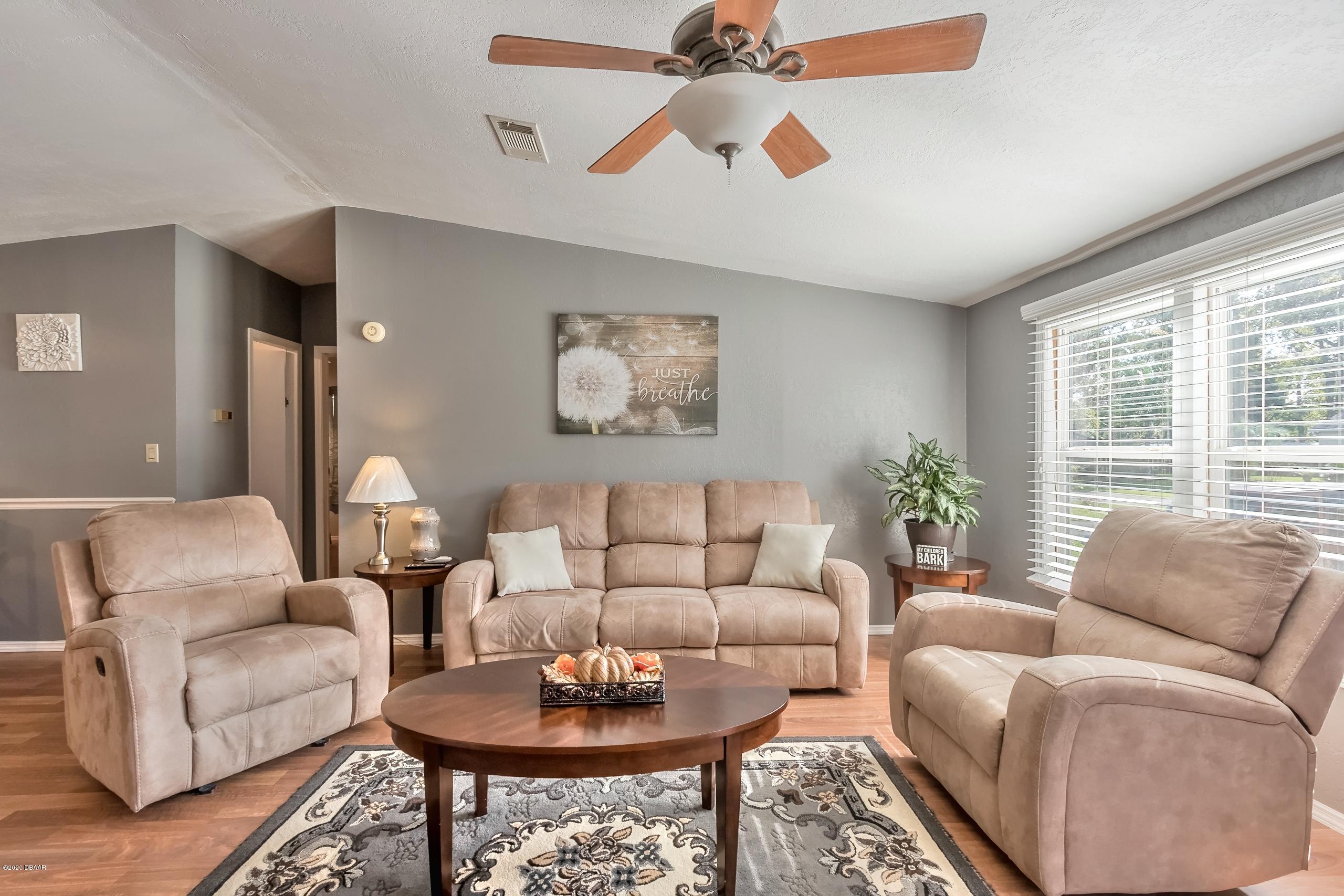 24513 Snail Road Astor, FL 32102 - Photo 10 of 40 a living room with furniture and a large window