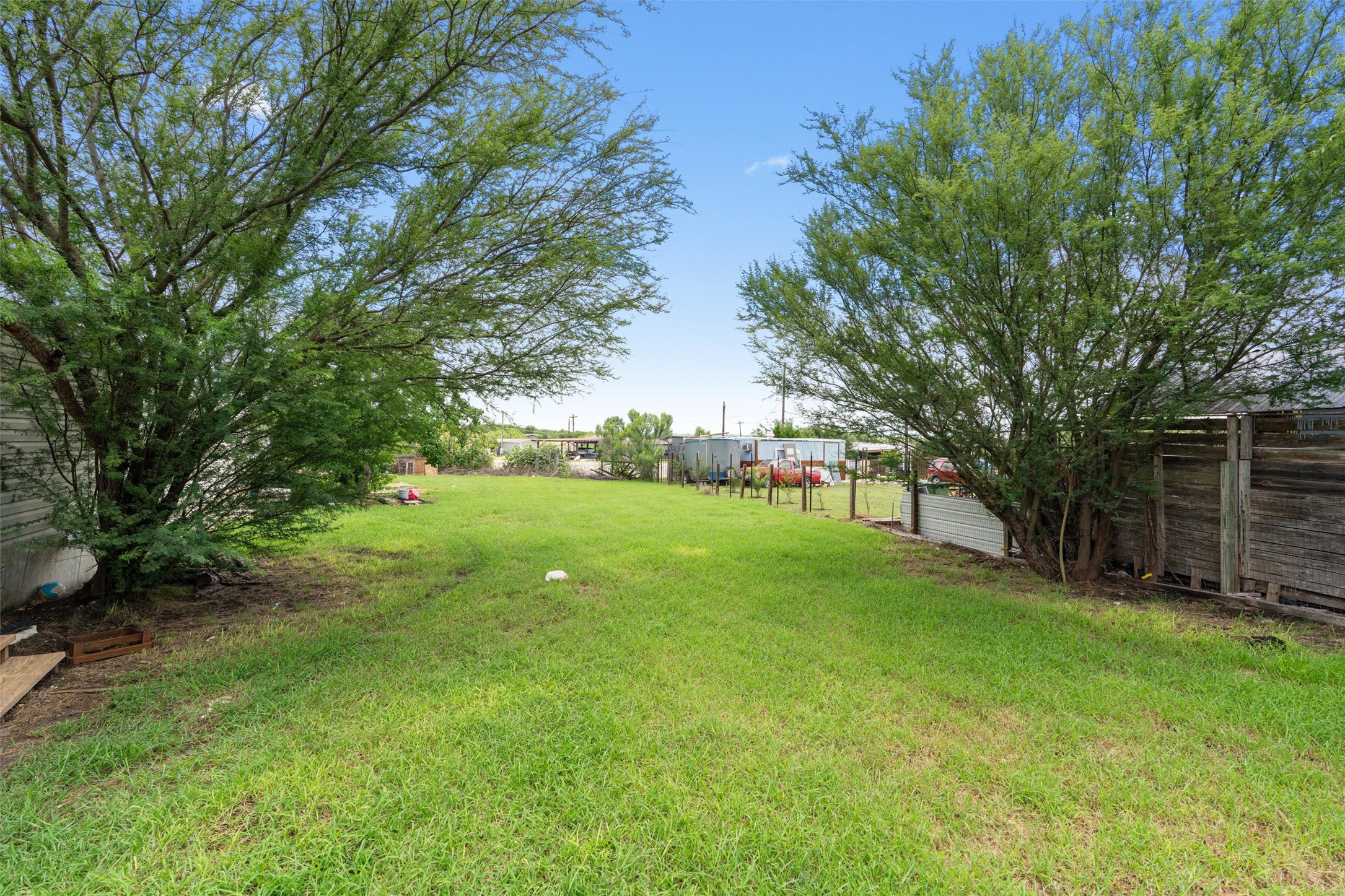 218 Boxcar Path Kyle, TX 78640 - Photo 14 of 21 A spacious, verdant yard framed by mature trees offers ample room for outdoor activities.