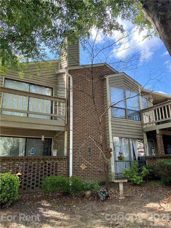 1604 Sharon Road West Charlotte, NC 28210 - Photo 1 of 15 a front view of a house with garden