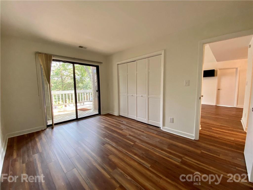 1604 Sharon Road West Charlotte, NC 28210 - Photo 12 of 15 a view of an empty room with wooden floor and a window