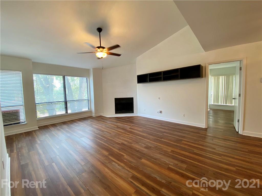 1604 Sharon Road West Charlotte, NC 28210 - Photo 3 of 15 a view of empty room with wooden floor and fan
