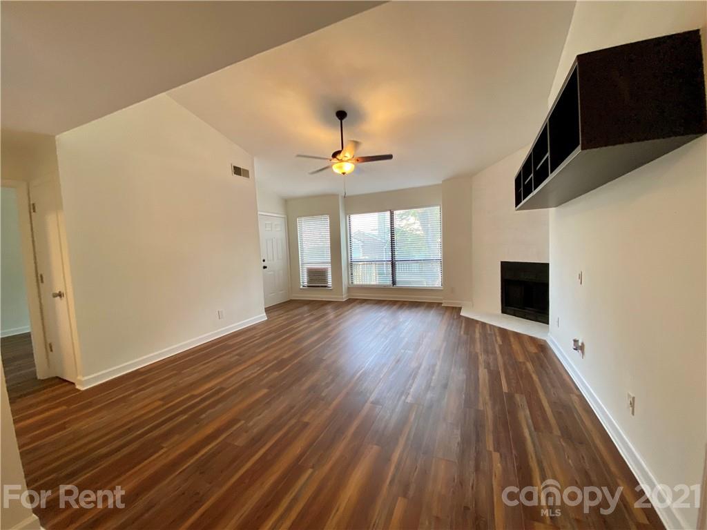 1604 Sharon Road West Charlotte, NC 28210 - Photo 4 of 15 wooden floor in an empty room with a window