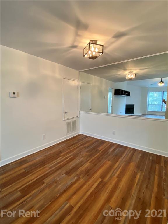 1604 Sharon Road West Charlotte, NC 28210 - Photo 5 of 15 wooden floor in an empty room with a window