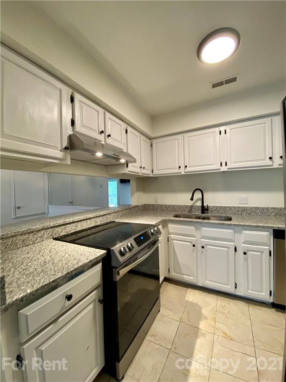 1604 Sharon Road West Charlotte, NC 28210 - Photo 6 of 15 a kitchen with cabinets appliances and a counter top space