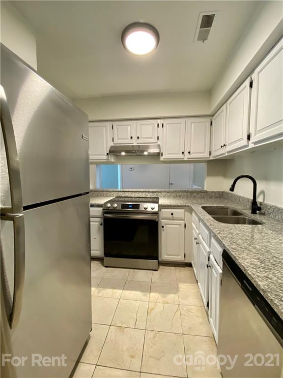 1604 Sharon Road West Charlotte, NC 28210 - Photo 7 of 15 a kitchen with a stove a sink and a refrigerator