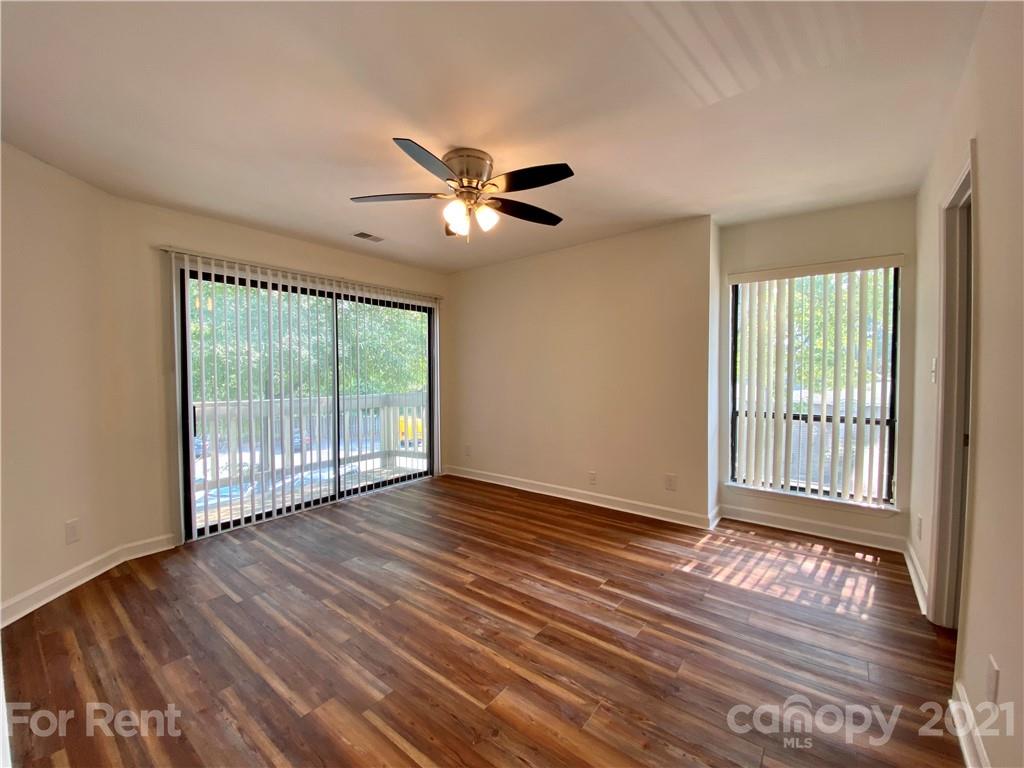 1604 Sharon Road West Charlotte, NC 28210 - Photo 8 of 15 a view of an empty room with wooden floor and a window