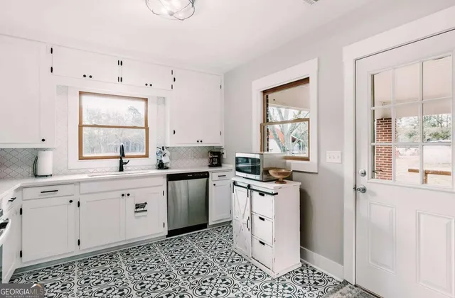 a kitchen with a sink cabinets and window