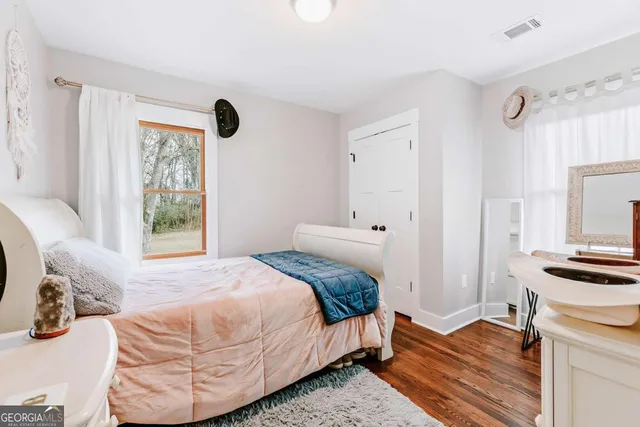 a bedroom with a bed and a dresser