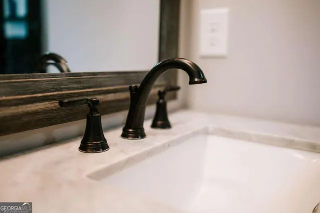 a front view of a house with large trees