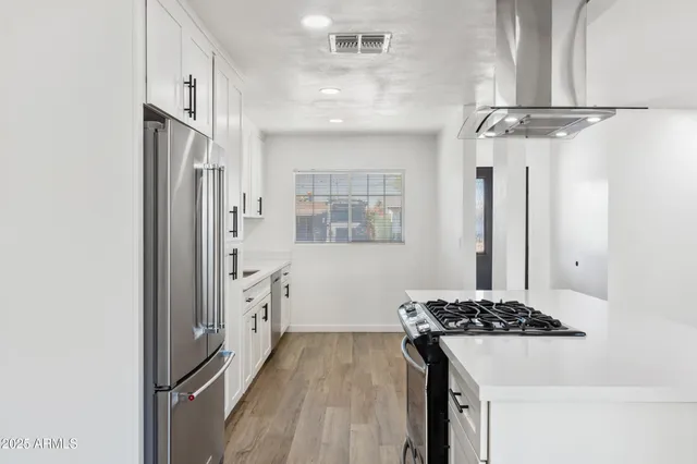 a kitchen with refrigerator and sink
