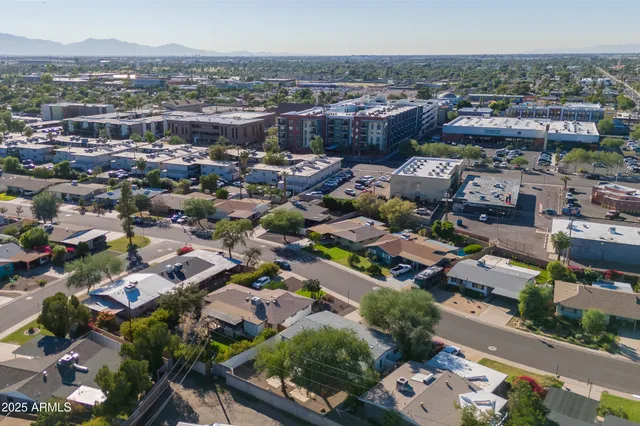 an aerial view of a house with a backyard space