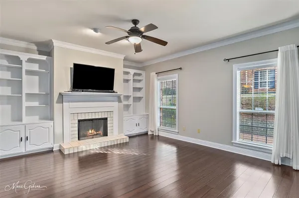 a living room with wooden floors and fireplace