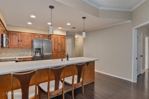 a kitchen with stainless steel appliances a sink stove and refrigerator