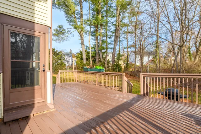 a view of a balcony with floor to ceiling windows and wooden fence