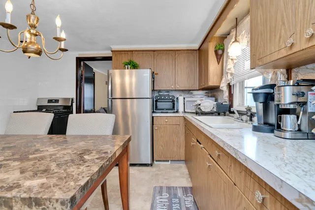 a kitchen with refrigerator and cabinets