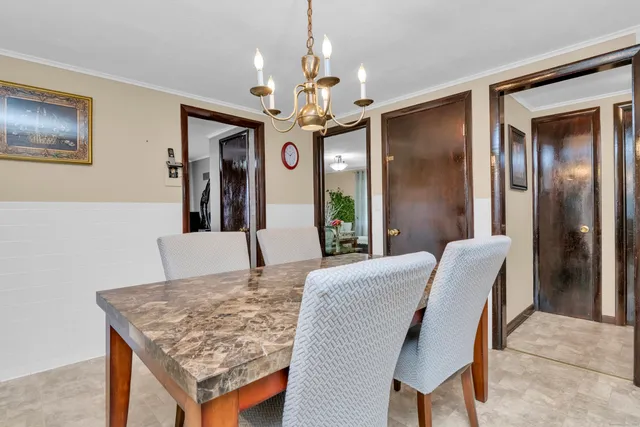 a dining room with a table chairs and refrigerator