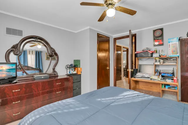 a bedroom with a bed and a dresser