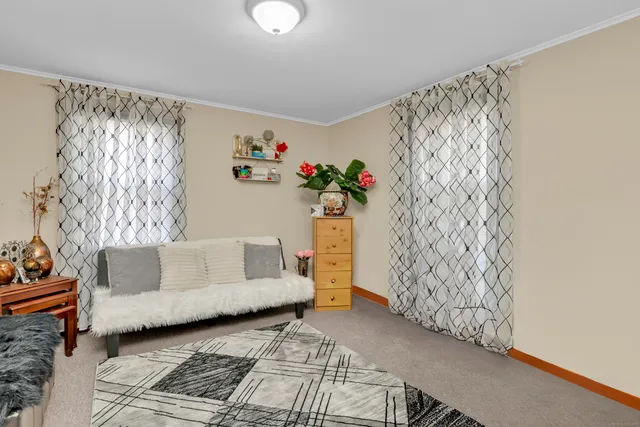 a living room with furniture and a wall painting