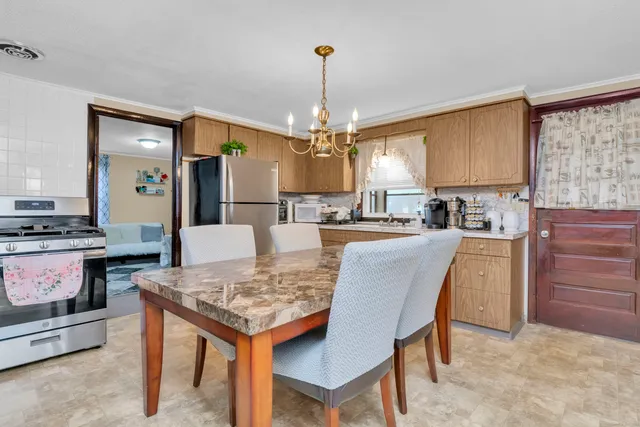 a kitchen with a table and chairs in it