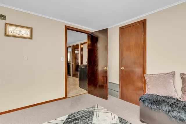 a bedroom with a bed and a view of bathroom