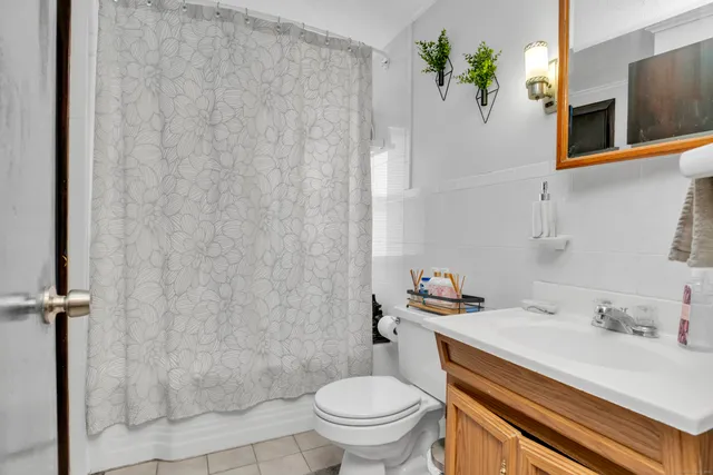 a view of bathroom with a toilet sink and mirror