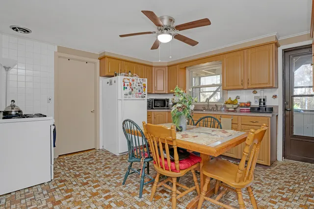 a kitchen with stainless steel appliances granite countertop a refrigerator a stove top oven a sink and dishwasher