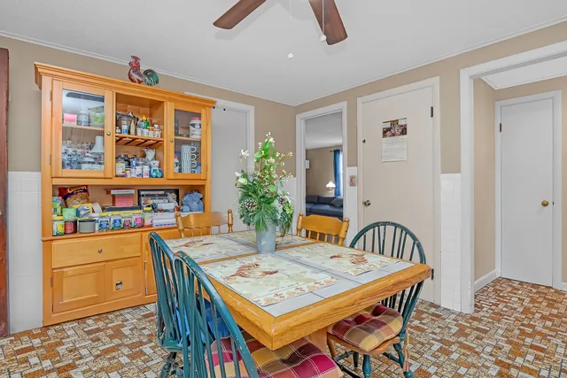 a dining room with furniture a rug and wooden floor