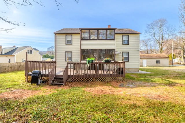 a front view of house with a garden and patio