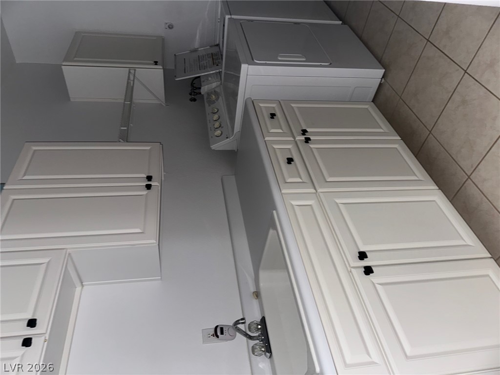 2050 West Warm Springs Road, Unit 1323 Henderson, NV 89014 - Photo 3 of 10 Enjoy the convenience of a dedicated laundry area with tile flooring and ample cabinetry.