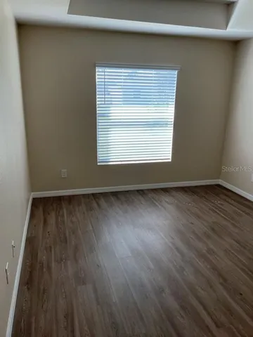 a view of an empty room and wooden floor