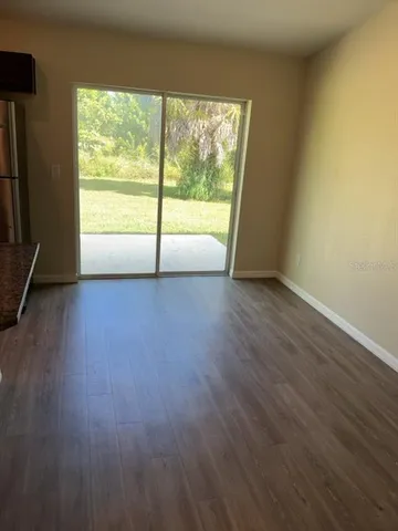 a view of a big room with wooden floor and doors
