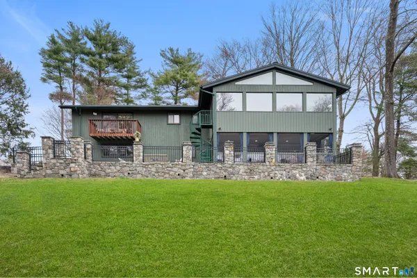 a front view of a house with swimming pool having outdoor seating