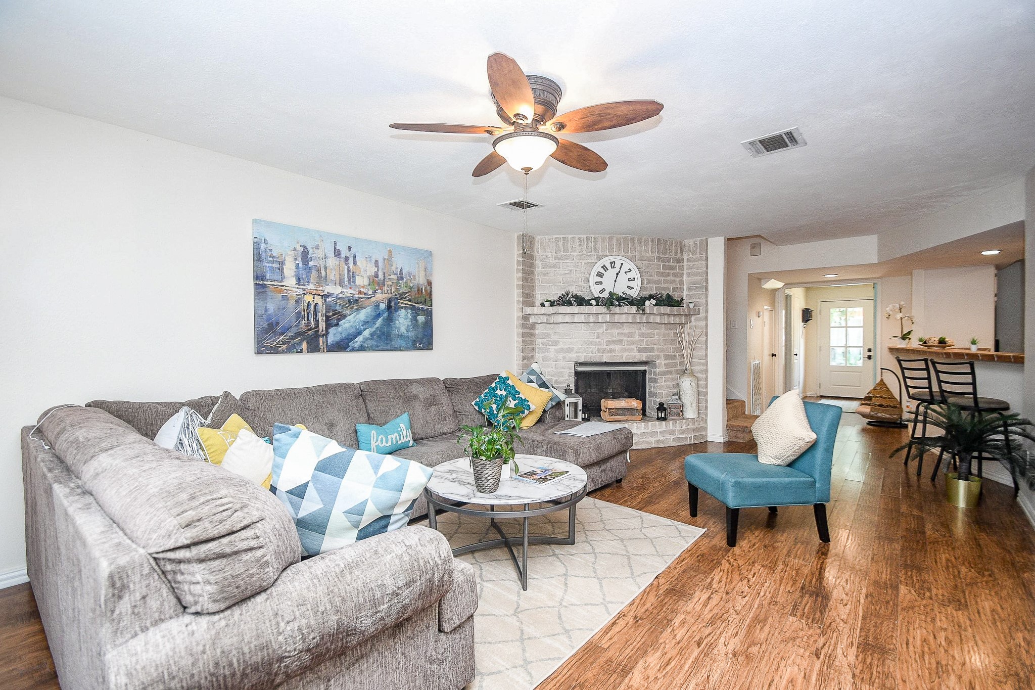 14686 Perthshire Road, Unit H Houston, TX 77079 - Photo 9 of 22 a living room with furniture a fireplace and a flat screen tv