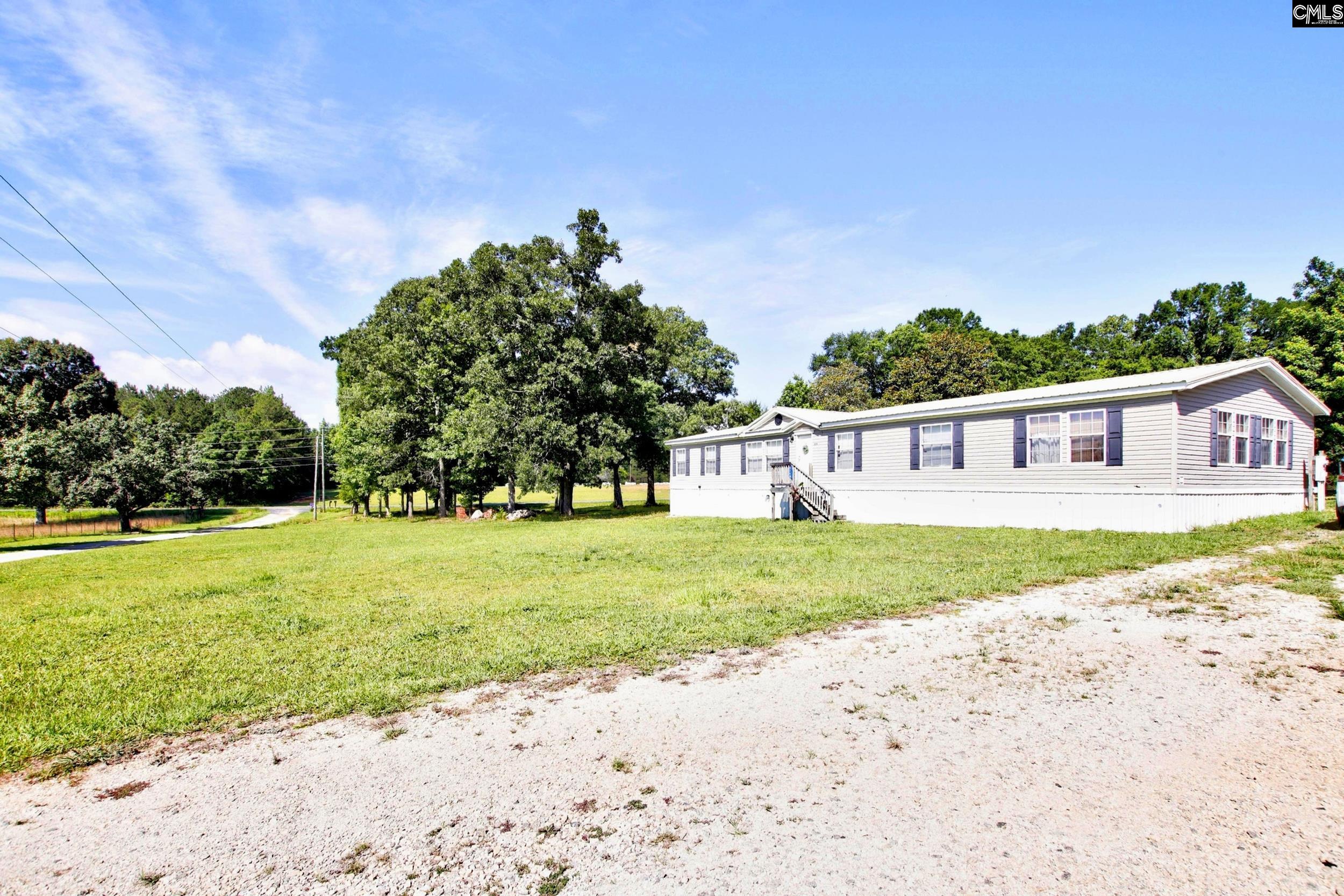 3140 Highway 702 Chappells, SC 29037 - Photo 20 of 39 a view of a house with backyard and trees