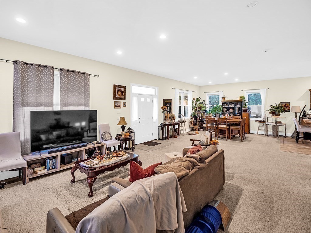 168 Proctor Road Chelmsford, MA 01824 - Photo 12 of 41 a living room with furniture and a flat screen tv