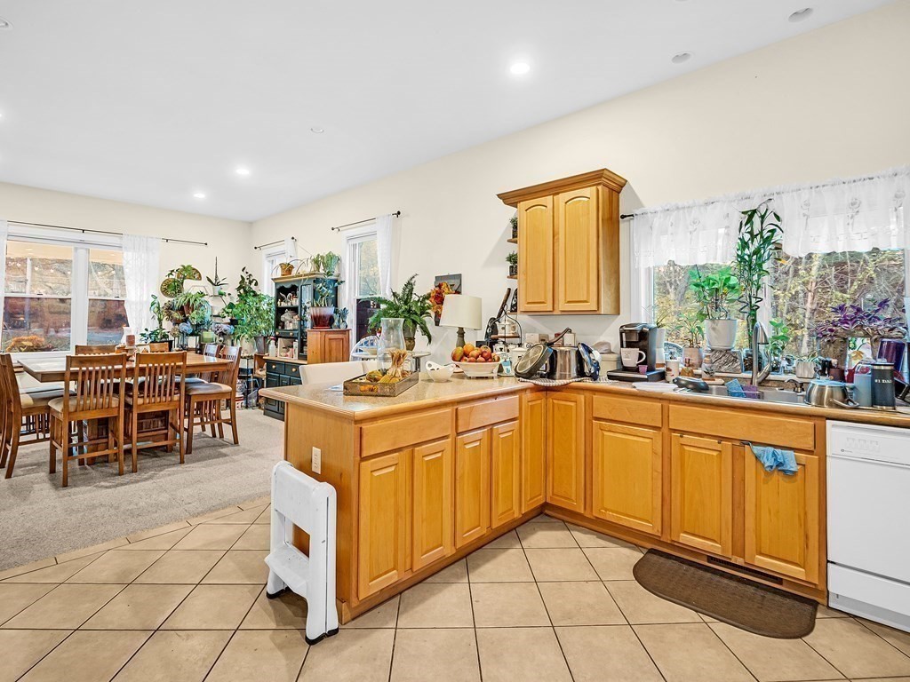 168 Proctor Road Chelmsford, MA 01824 - Photo 20 of 41 a large white kitchen with cabinets and chairs