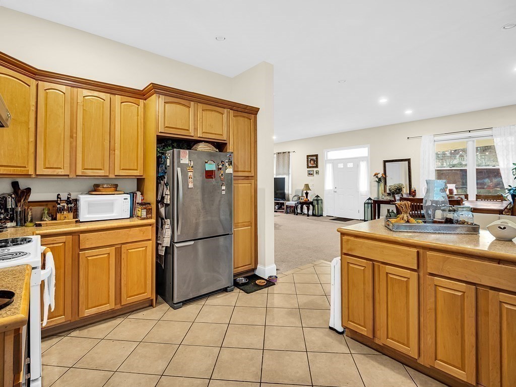 168 Proctor Road Chelmsford, MA 01824 - Photo 21 of 41 a kitchen with stainless steel appliances granite countertop a refrigerator and a stove top oven
